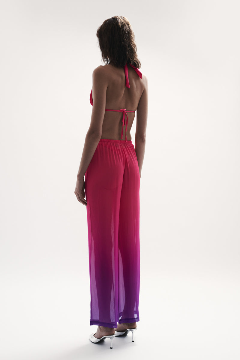side view elegant woman wearing luxury swimwear from sommer swim - capri berry crush is stylish pant