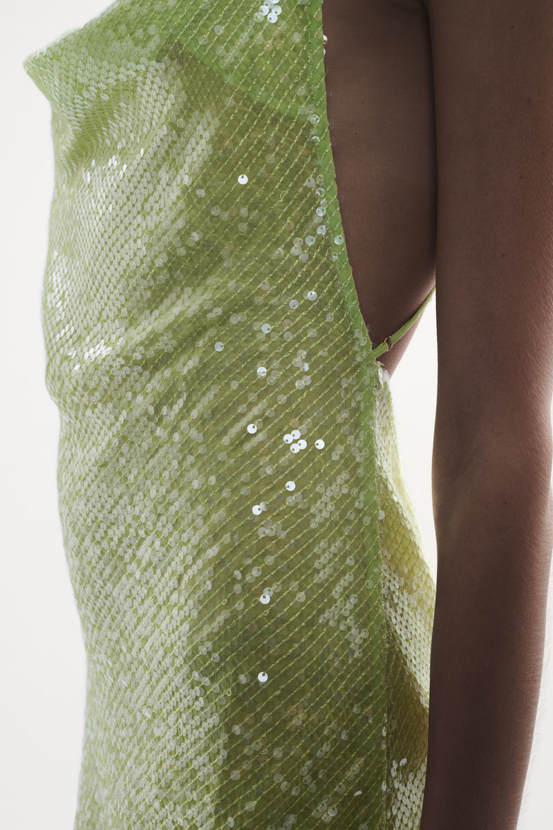 close up side view elegant woman wearing luxury wear from sommer swim - ibiza chartreuse is a light green sequin mini dress