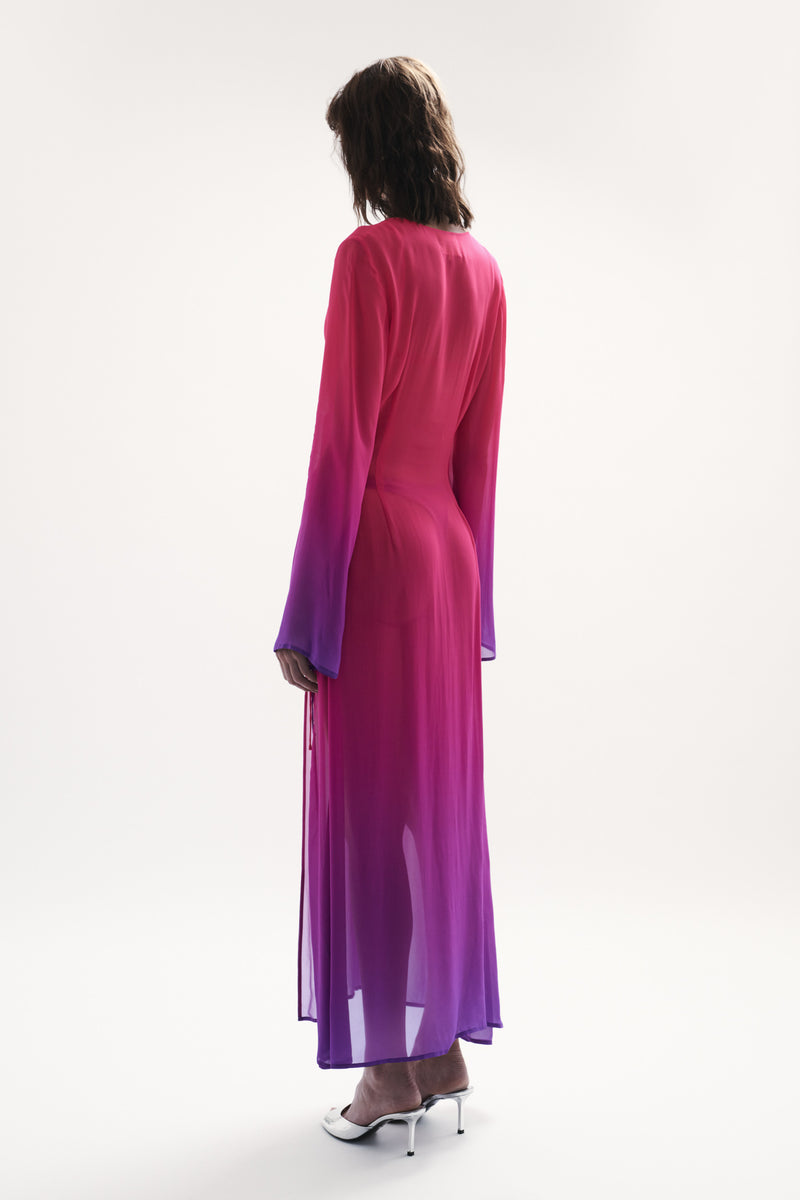 side view elegant woman wearing luxury swimwear from sommer swim - pelicano berry crush is a pink and purple gradient robe dress