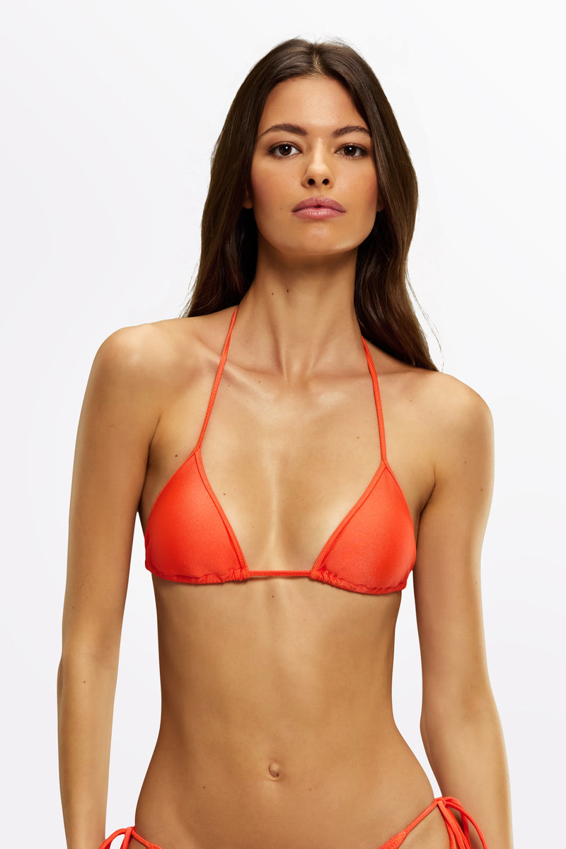 Model wearing the Lotta triangle bikini top in Ipanema print with adjustable neck and back ties – luxury bikini top for summer.