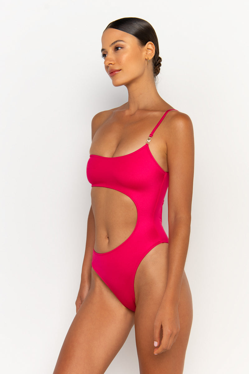 side view elegant woman wearing luxury swimsuit from sommer swim - bonita magenta is an fuchsia one piece one shoulder swimsuit
