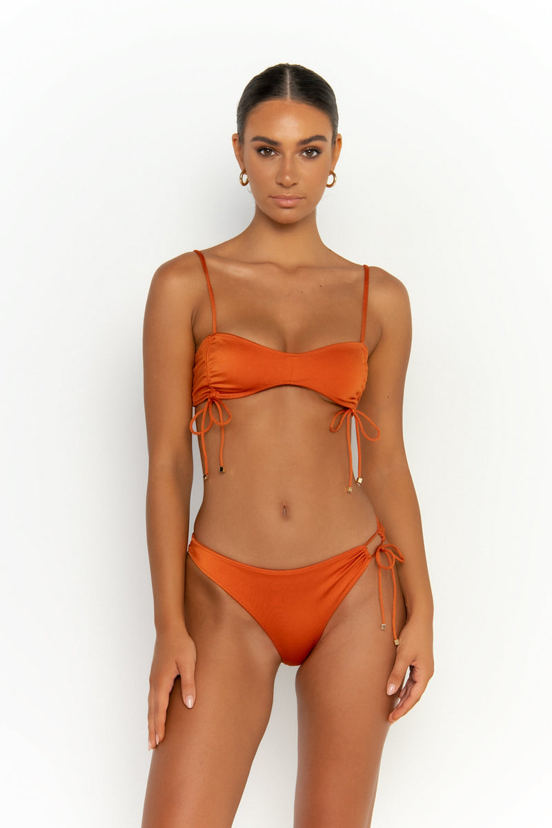 front view elegant woman wearing luxury swimsuit from sommer swim - adriana egitto is a dark orange bikini with high waisted bikini bottom
