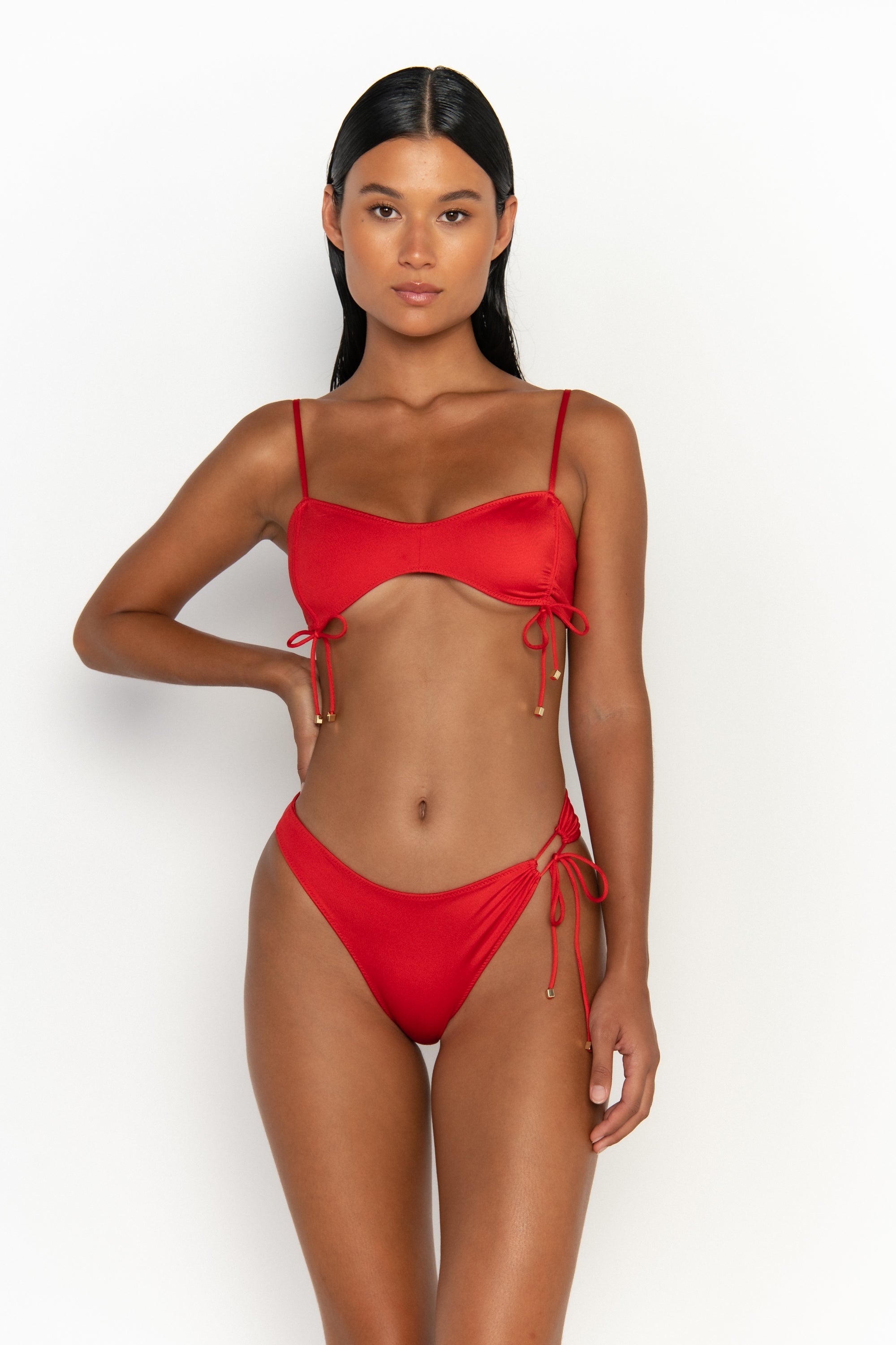 front view elegant woman wearing luxury swimsuit from sommer swim - bea siren is a red bikini with bralette bikini top