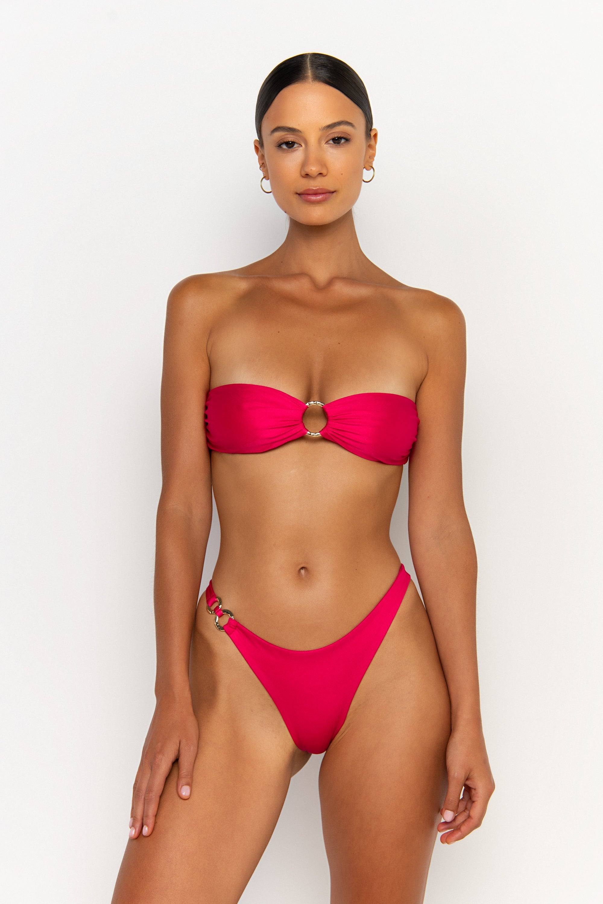 front view elegant woman wearing luxury swimsuit from sommer swim - cece magenta is a fuchsia bikini with a bandeau bikini top