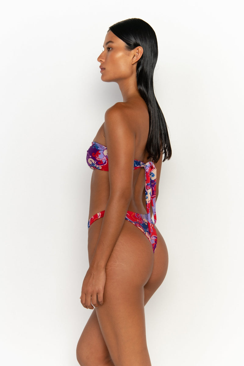 back view elegant woman wearing luxury swimsuit from sommer swim - cece rococo is a print bikini with a bandeau bikini top