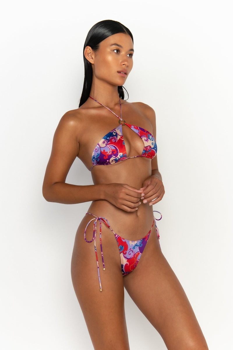 side view elegant woman wearing luxury swimsuit from sommer swim - celene rococo is a print bikini with a halter style bikini top
