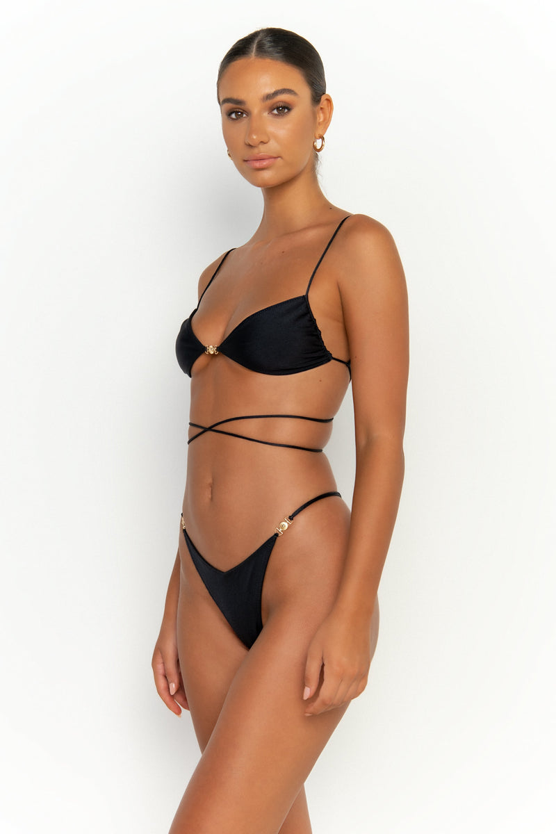 second side view elegant woman wearing luxury swimsuit from sommer swim - ella nero is a black bikini with bralette bikini top