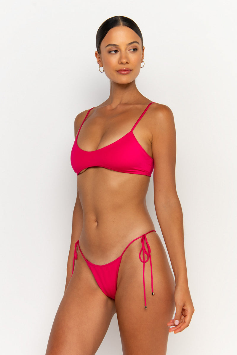 side view elegant woman wearing luxury swimsuit from sommer swim - freya magenta is a fuchsia bikini with tie side bikini bottom