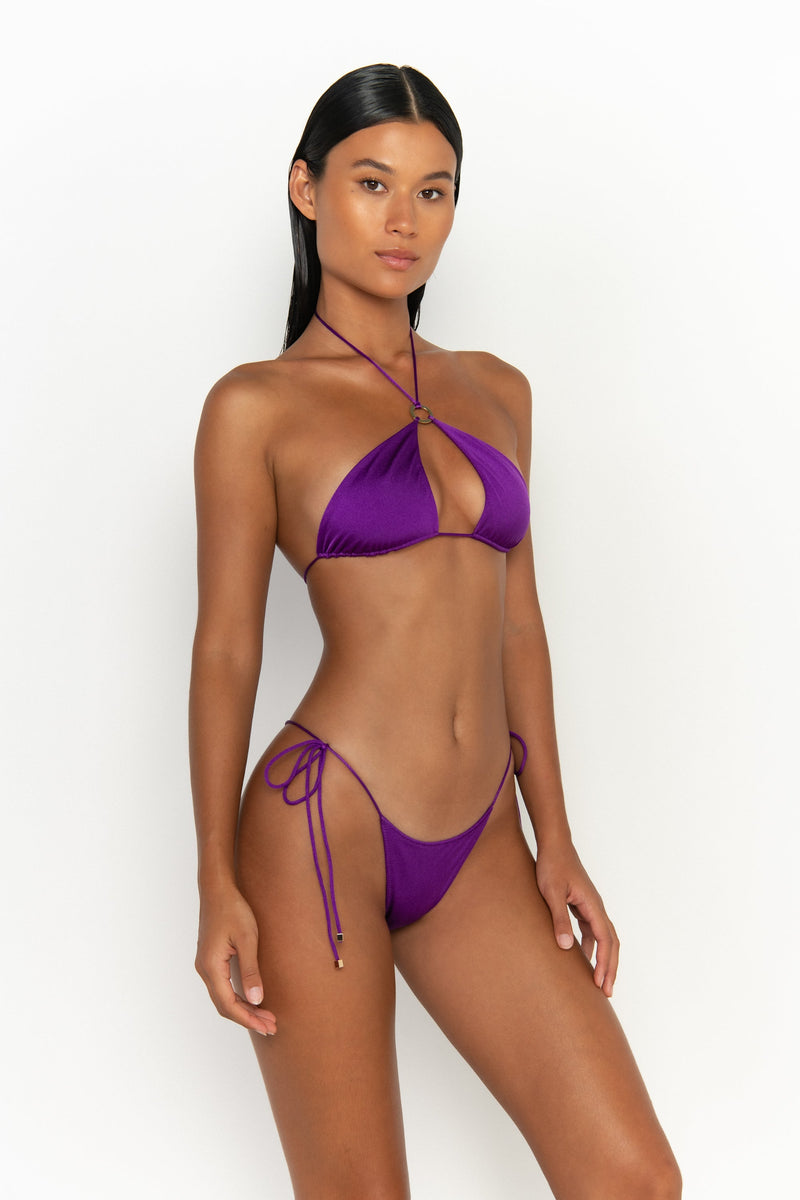 side view elegant woman wearing luxury swimsuit from sommer swim - freya petunia is a purple bikini with tie side bikini bottom