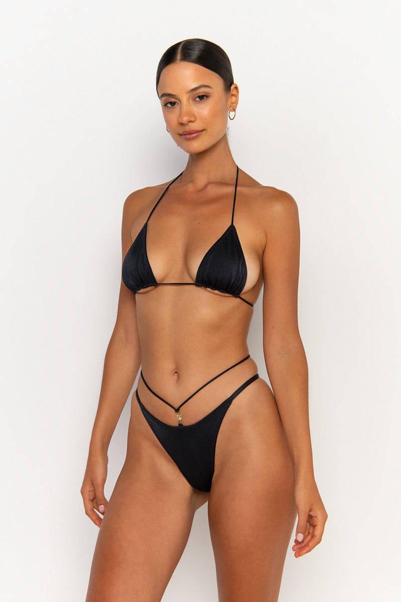 side view elegant woman wearing luxury swimsuit from sommer swim - kamilla nero is a black bikini with brazilian bikini bottom