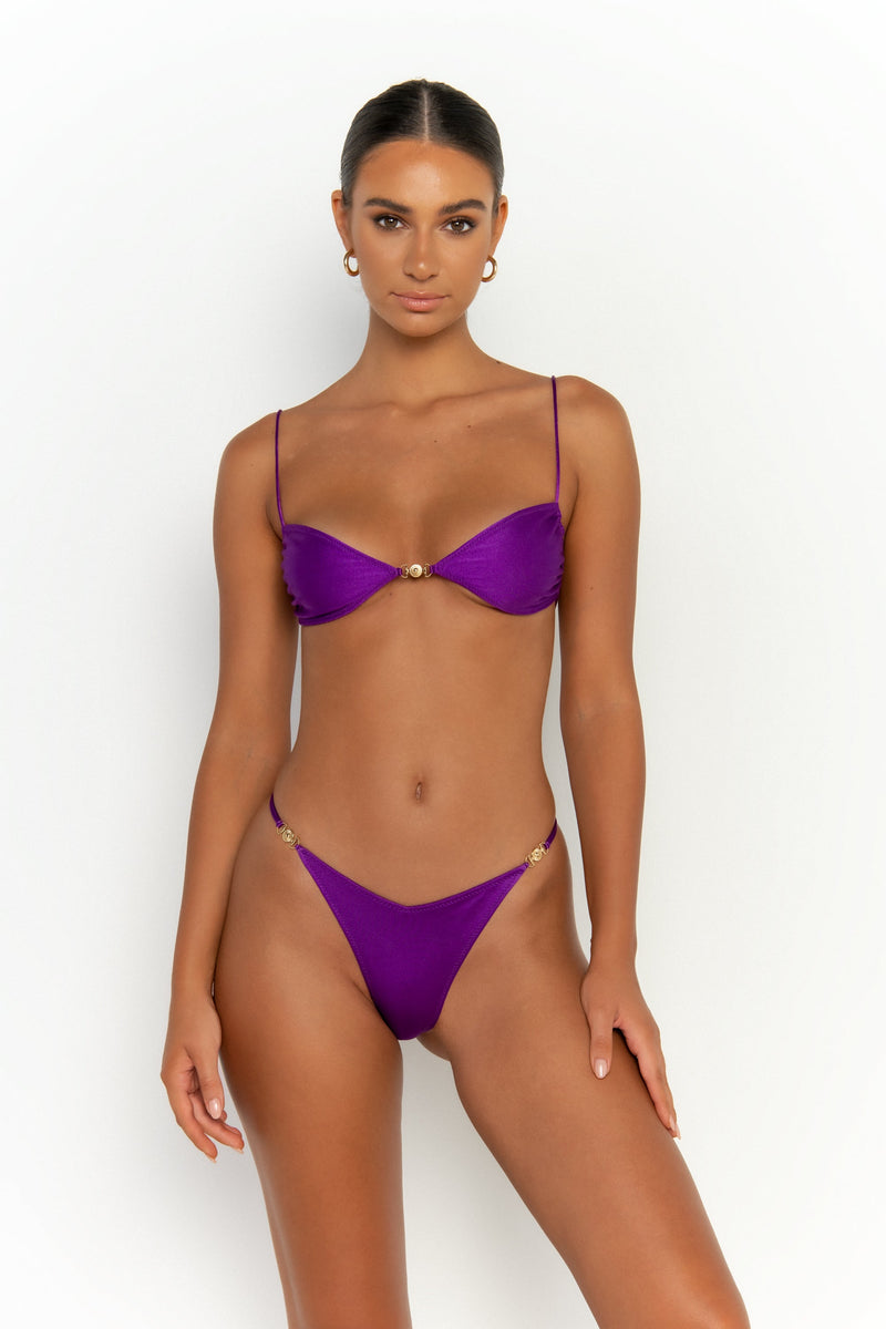 front view elegant woman wearing luxury swimsuit from sommer swim - lia petunia is a purple bikini with brazilian bikini bottom