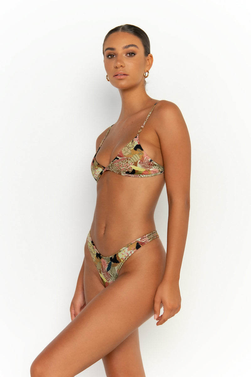 side view elegant woman wearing luxury swimsuit from sommer swim - niam jaguar is a print bikini with thong bikini bottom