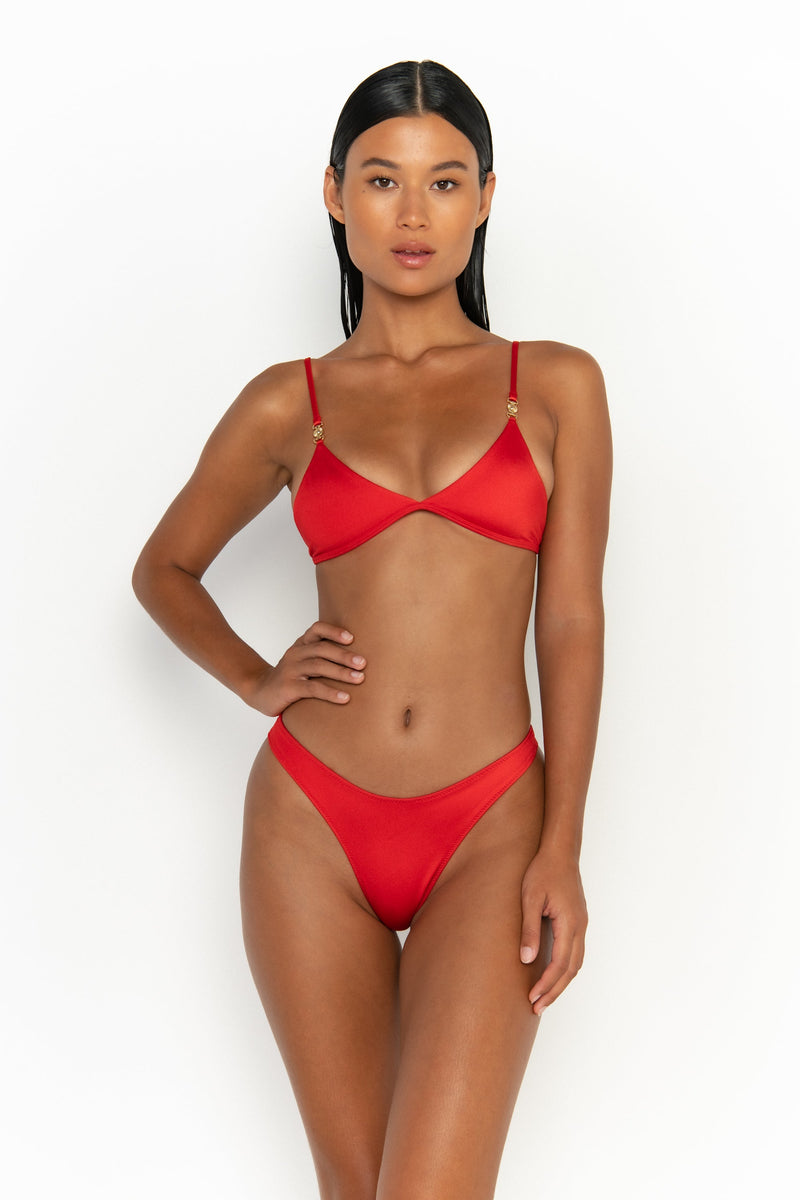 front view elegant woman wearing luxury swimsuit from sommer swim - niam siren is a red bikini with thong bikini bottom