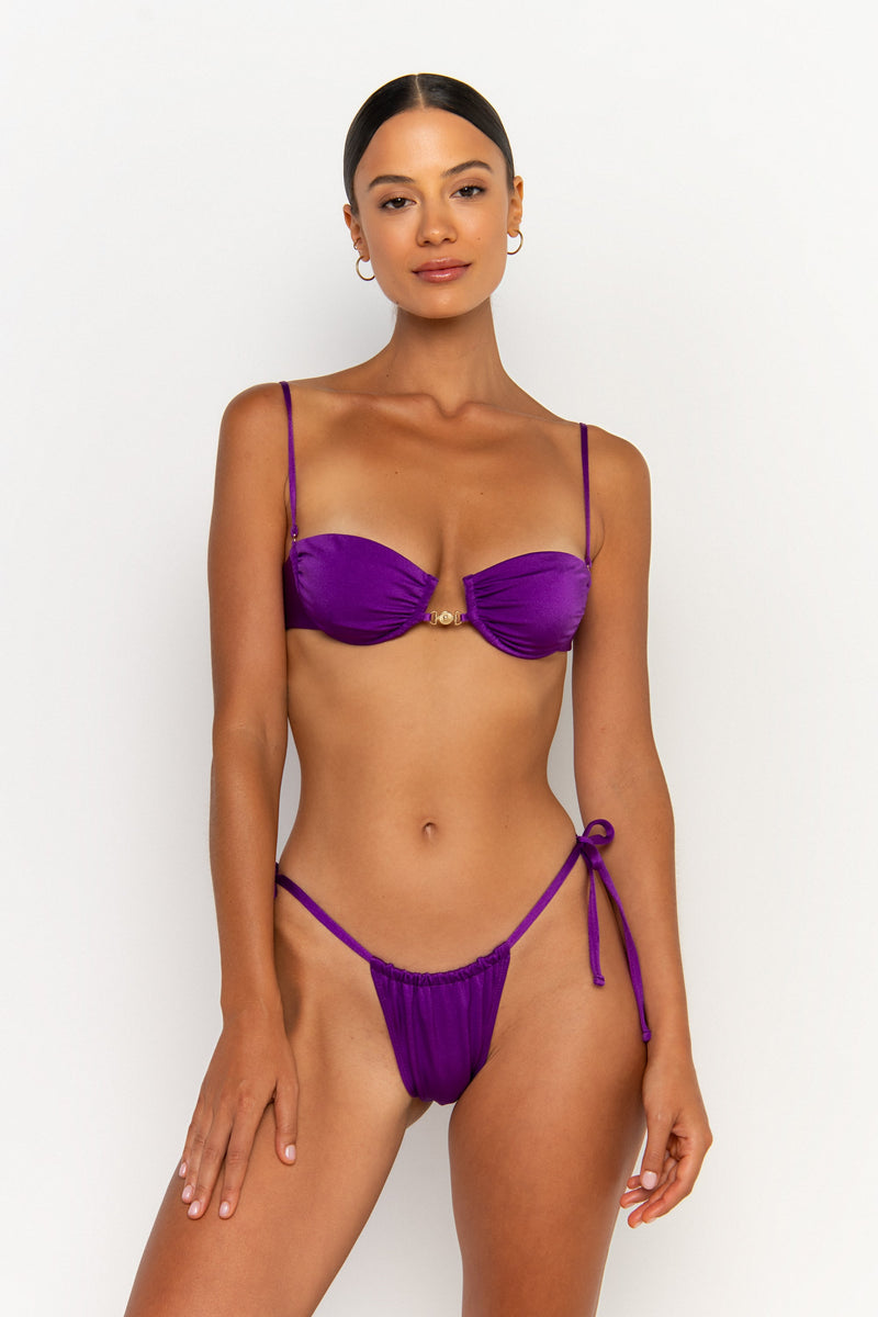 front view elegant woman wearing luxury swimsuit from sommer swim - paloma petunia is a purple bikini with tie side bikini bottom