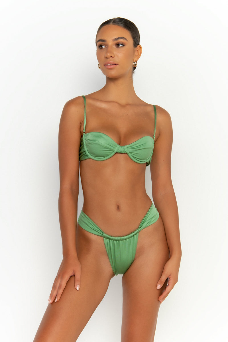 front looking sideways view elegant woman wearing luxury swimsuit from sommer swim - rylee maltese is a mint green bikini with balconette bikini top