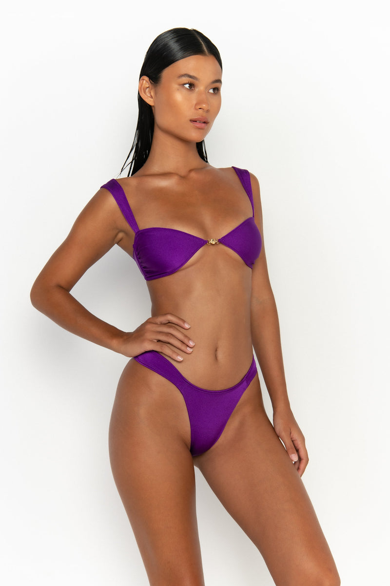 side view elegant woman wearing luxury swimsuit from sommer swim - soriya petunia is a purple bikini with balconette bikini top