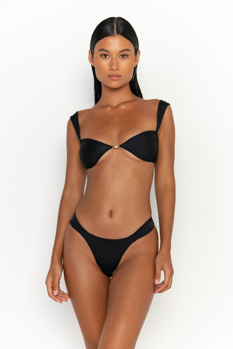 front view elegant woman wearing luxury swimsuit from sommer swim - zita nero is a black bikini with cheeky bikini bottom