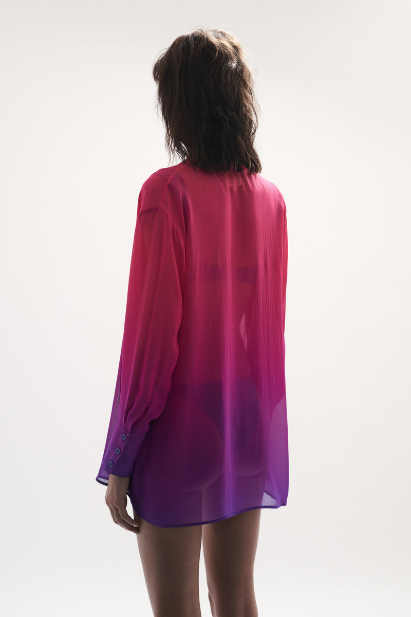 back view elegant woman wearing luxury resort wear from sommer swim - havana berry crush is a pink and purple shirt displayed fully outfit with pants