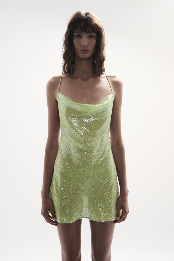 front view elegant woman wearing luxury wear from sommer swim - ibiza chartreuse is a light green sequin mini dress