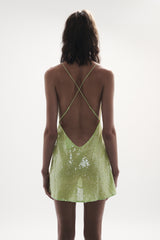 back view elegant woman wearing luxury resort wear from sommer swim - ibiza chartreuse is a light green sequin mini dress