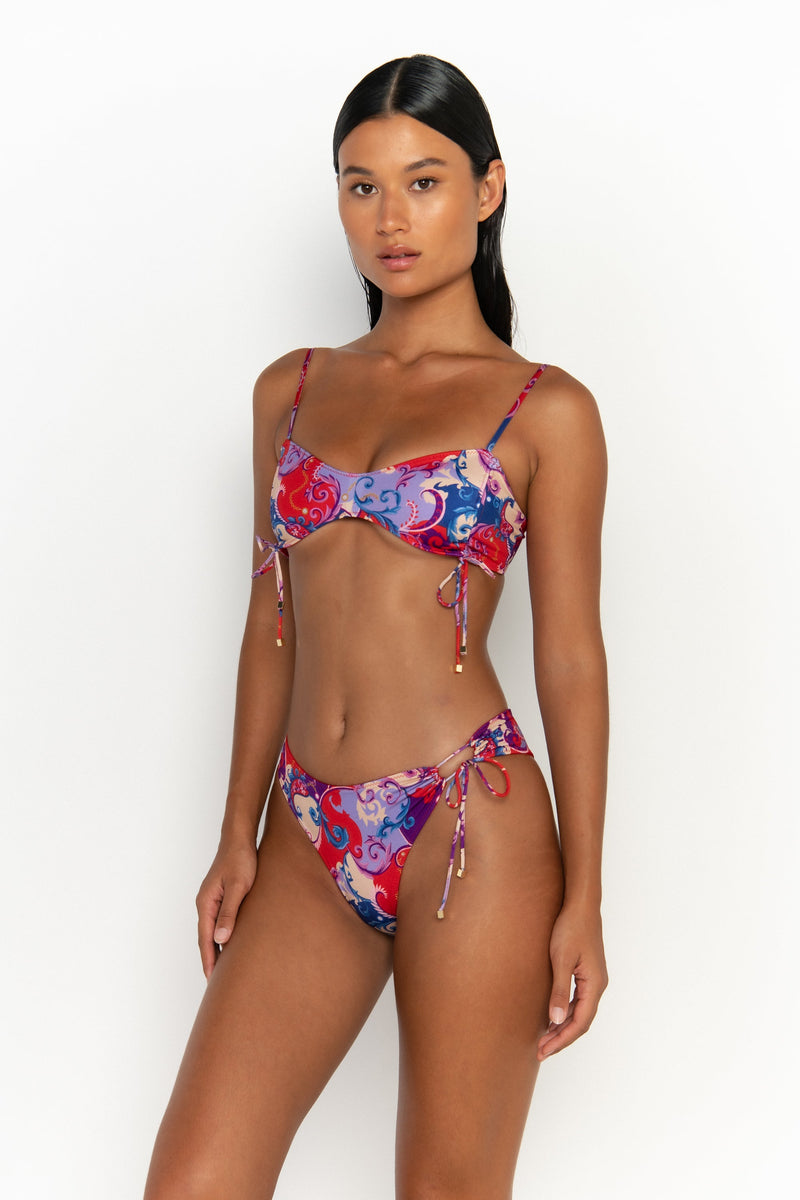 side looking forward view elegant woman wearing luxury swimsuit from sommer swim - bea rococo is a print bikini with bralette bikini top