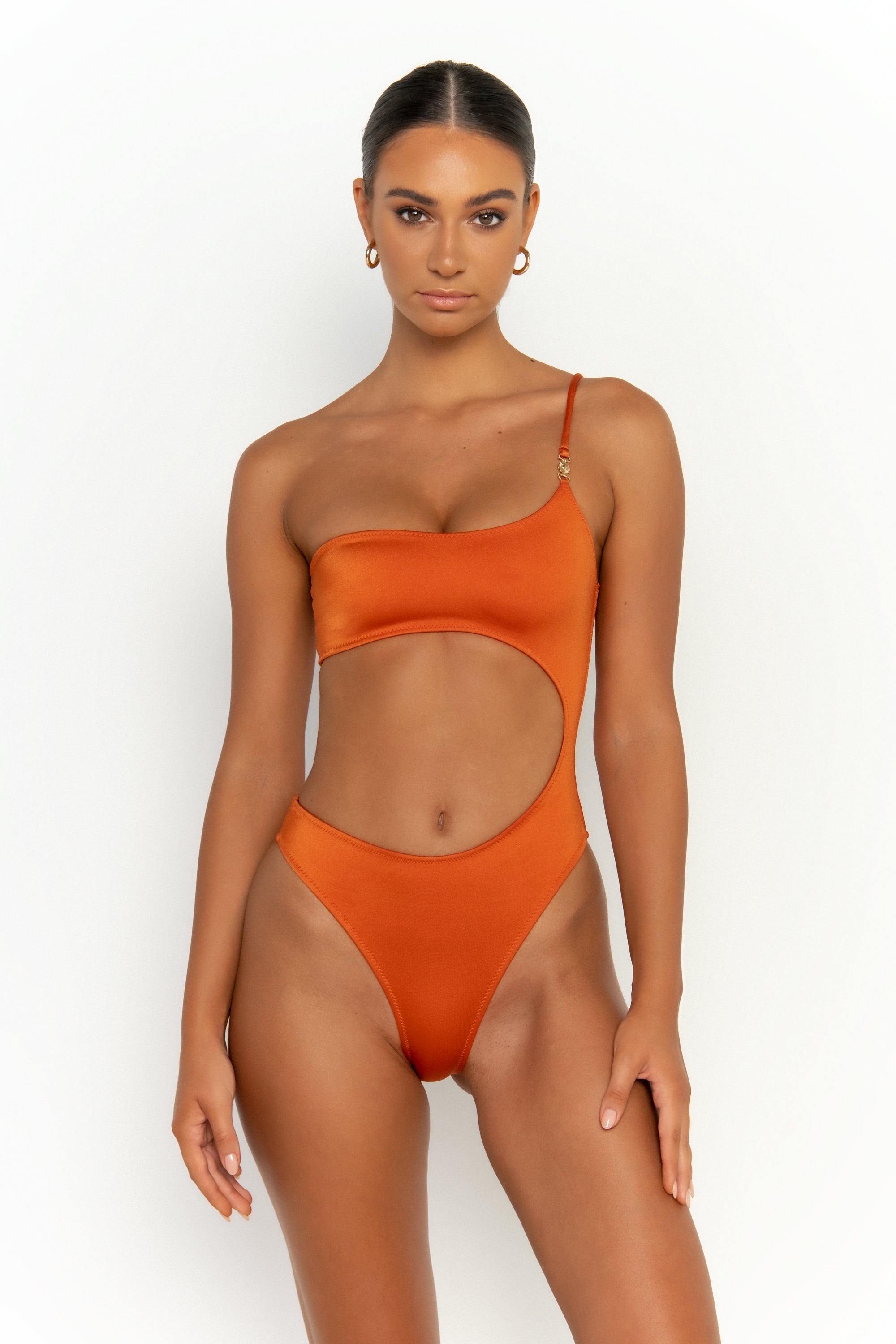 front view elegant woman wearing luxury swimsuit from sommer swim - bonita egitto is an dark orange one piece one shoulder swimsuit