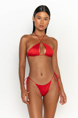 front view elegant woman wearing luxury swimsuit from sommer swim - celene siren is a red bikini with a halter style bikini top