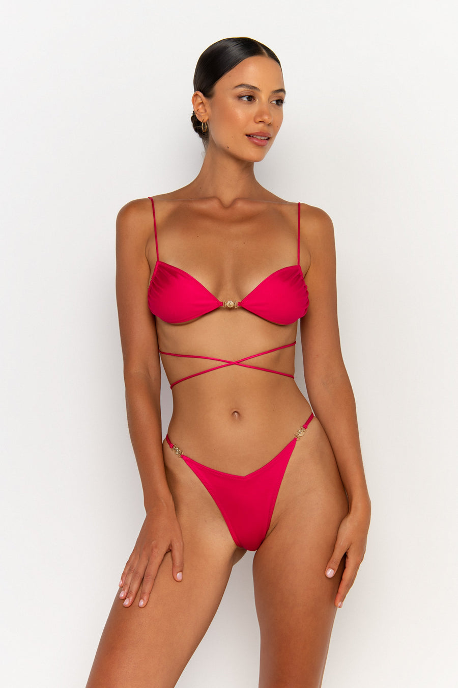 side view elegant woman wearing luxury swimsuit from sommer swim - ella magenta is a fuchsia bikini with bralette bikini top
