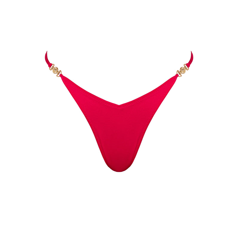Close-up of the gold hardware and luxurious finish of the Lia Magenta Brazilian bikini bottom.
