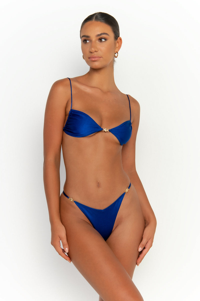 front view elegant woman wearing luxury swimsuit from sommer swim - lia olympus is a royal blue bikini with brazilian bikini bottom