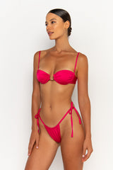 side view elegant woman wearing luxury swimsuit from sommer swim - paloma magenta is a fuchsia bikini with tie side bikini bottom